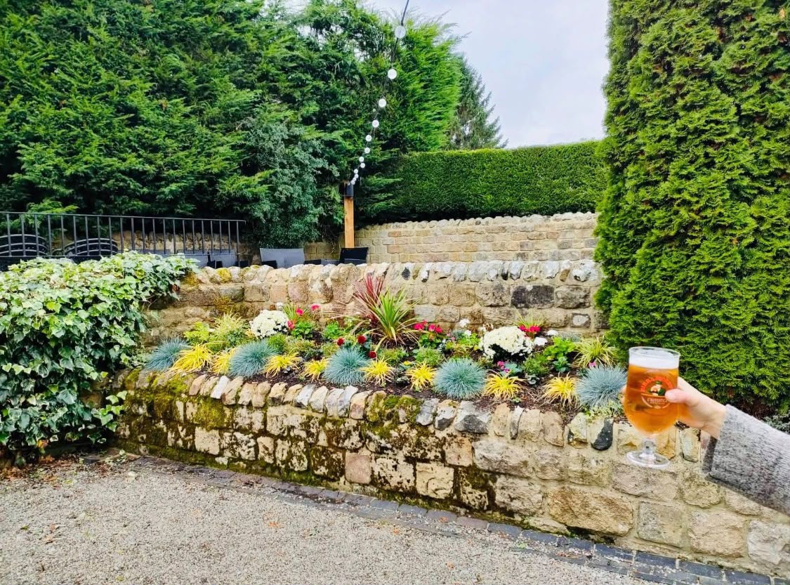 A memorial garden with a bench, gravel bed and mixed planting built in the grounds of a Harrogate school