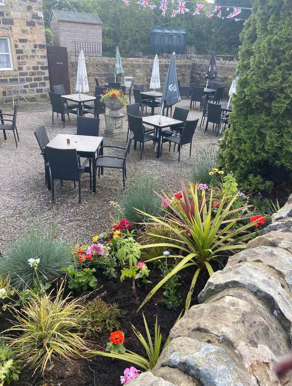 A commercial planting bed made up and planted outside a bar and restaurant