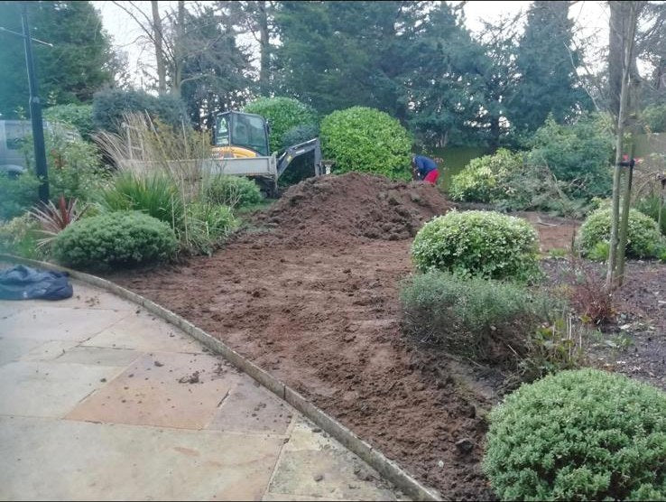 A bed dug over and levelled by mini digger before new turf went down