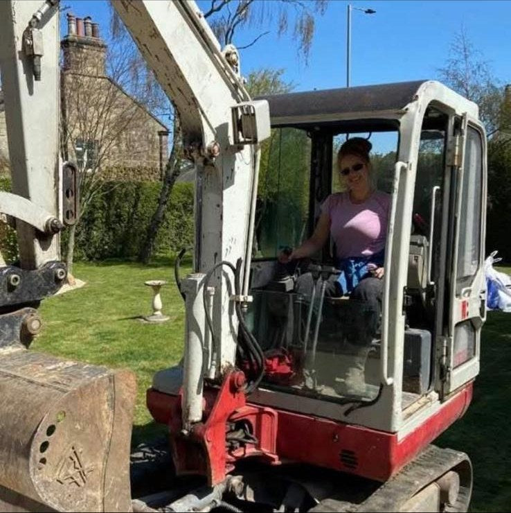 Karen on the digger on a landscaping job