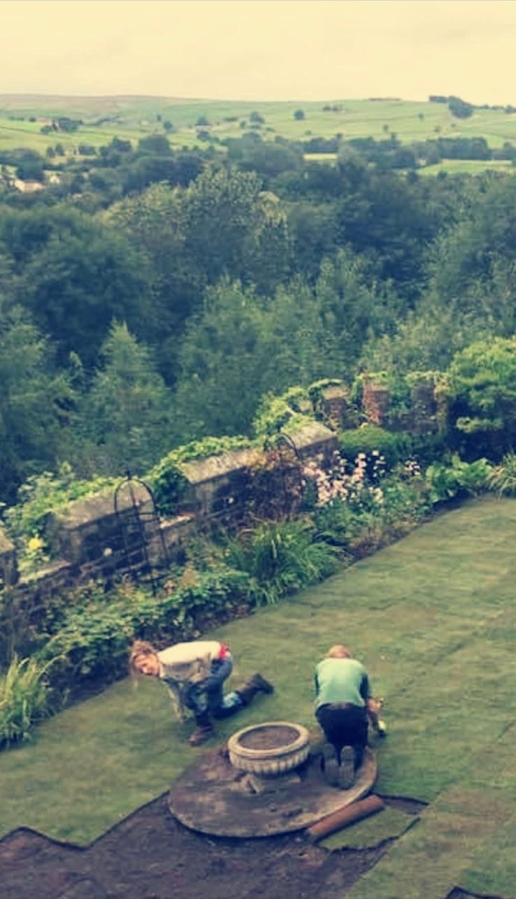 Building a circular stone feature on a hillside lawn