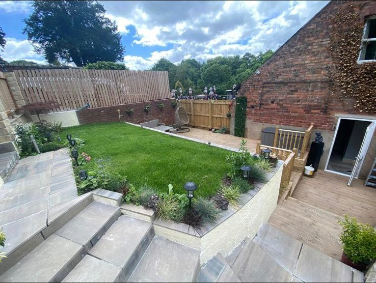 The same garden finished: new lawn, stone steps and a planted border