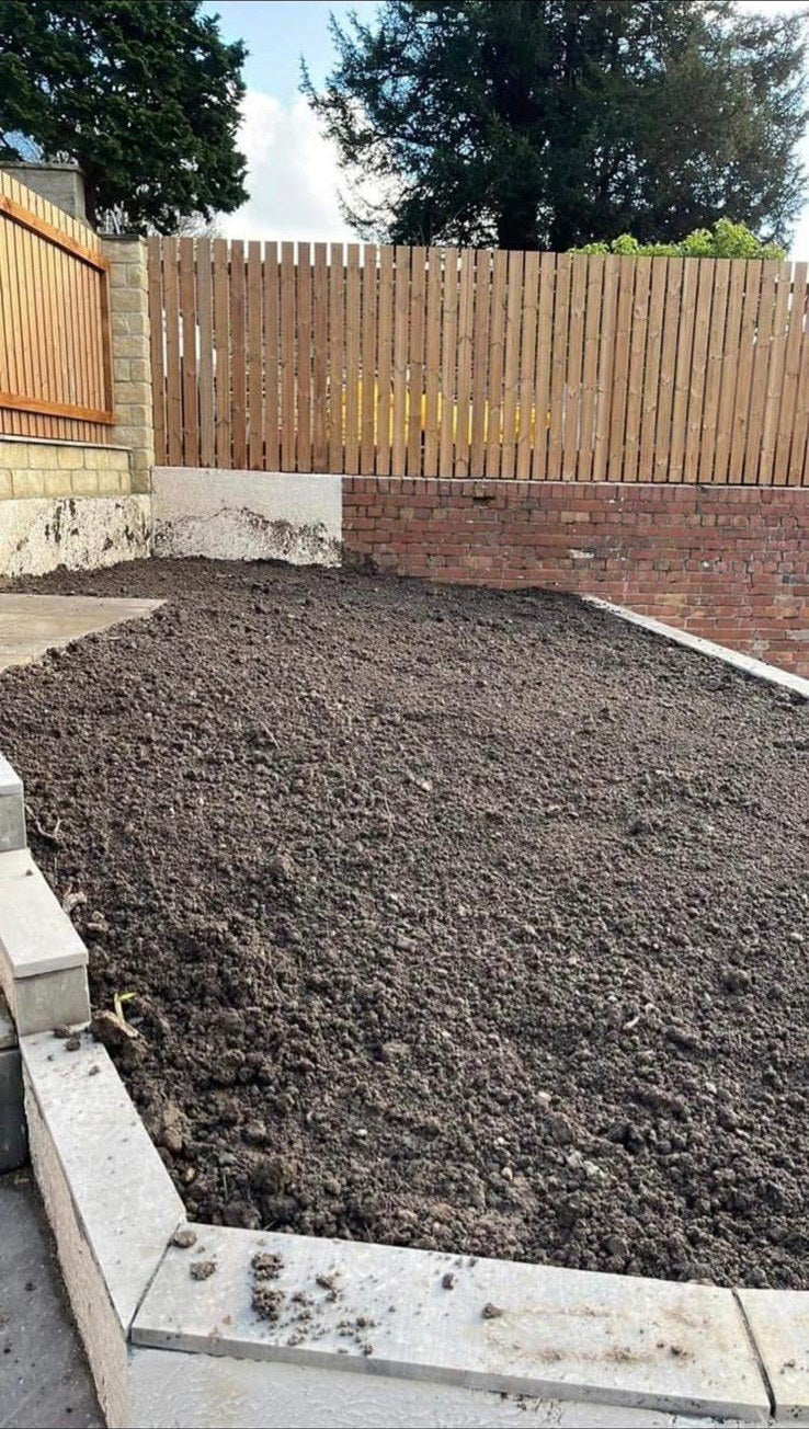 A bed edged with new kerbs, the soil raked and ready for turf