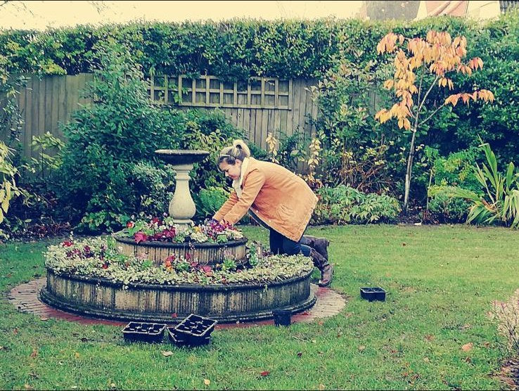 One of the team planting up a circular stone bed